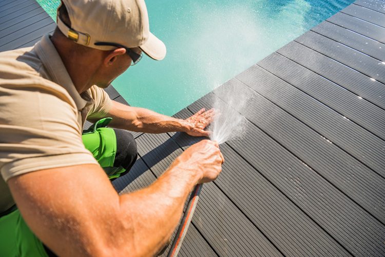 Man cleaning composite 
decking