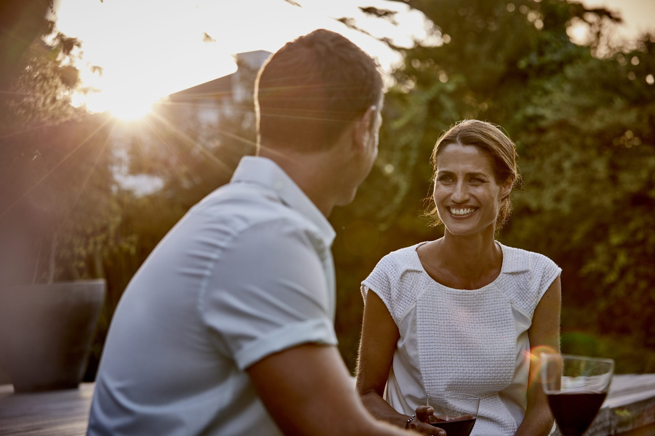 Man and woman having wine on top of composite decking
