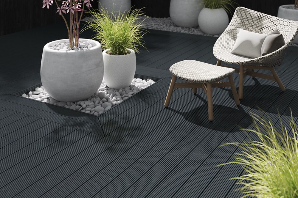 Essentials dark grey budget decking with seats and plants