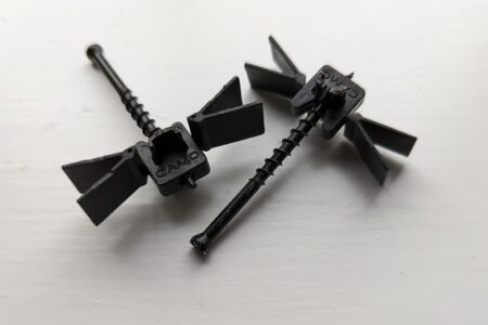 Two black composite decking clips