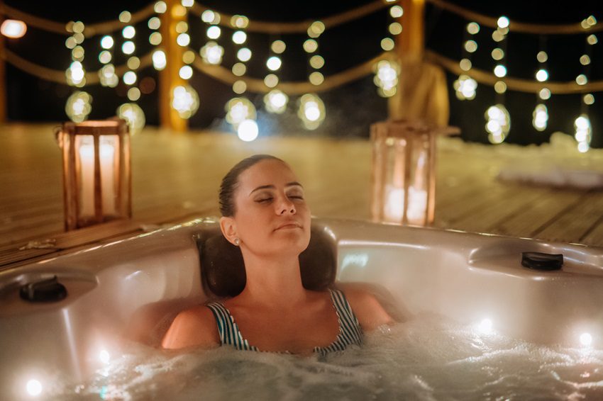 Woman relaxing in a hot tub