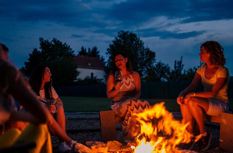 Group of people around a fire pit on composite decking