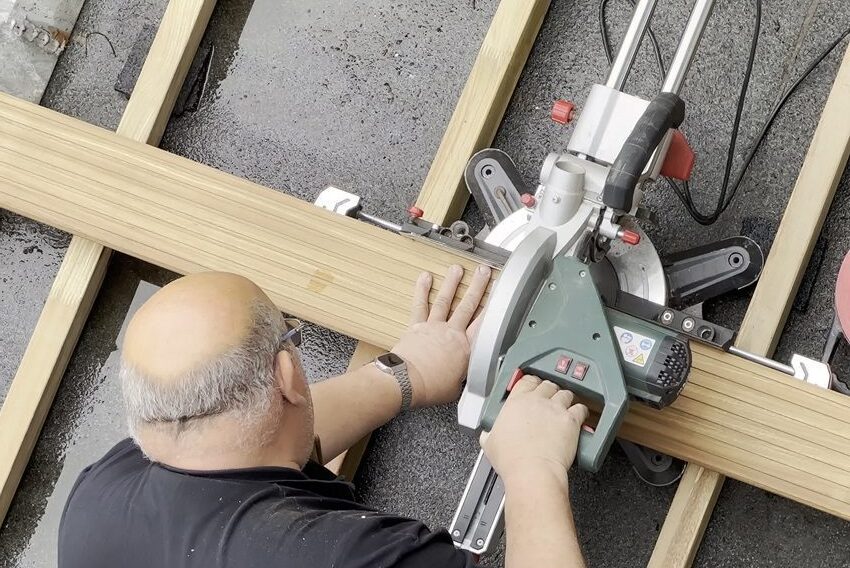 Man cutting composite wood boards