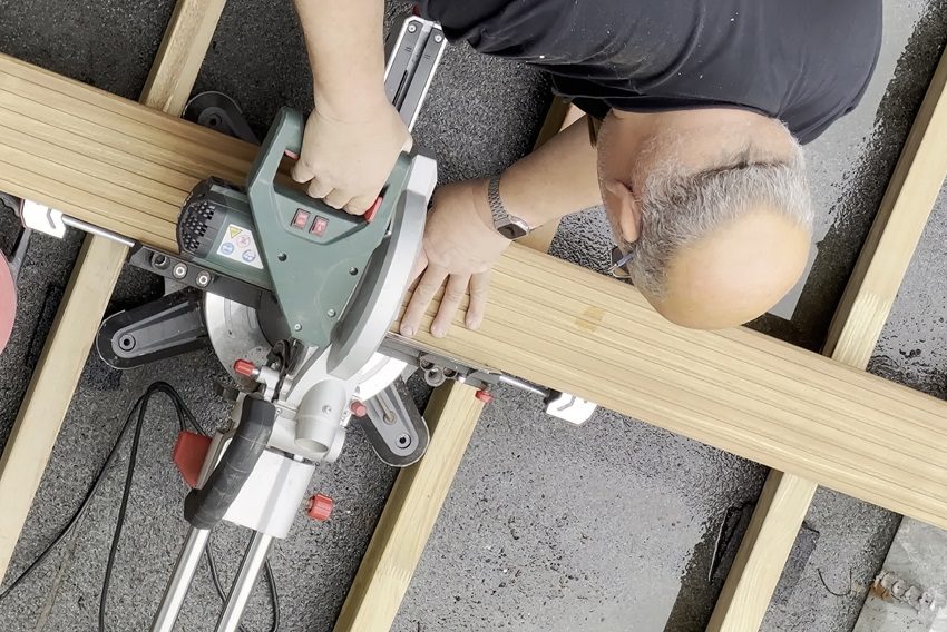Man cutting composite wood boards