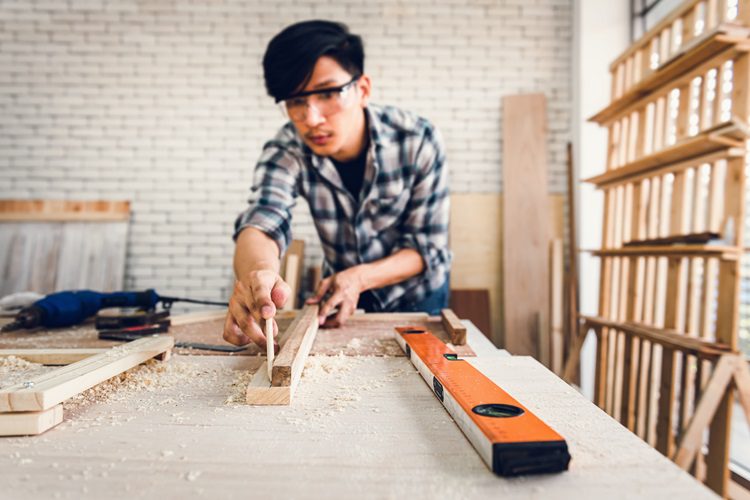 Man making a table from composite and timber