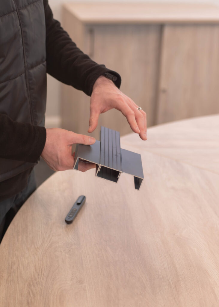 Ecodek team member demonstrating Adek non-combustible decking.