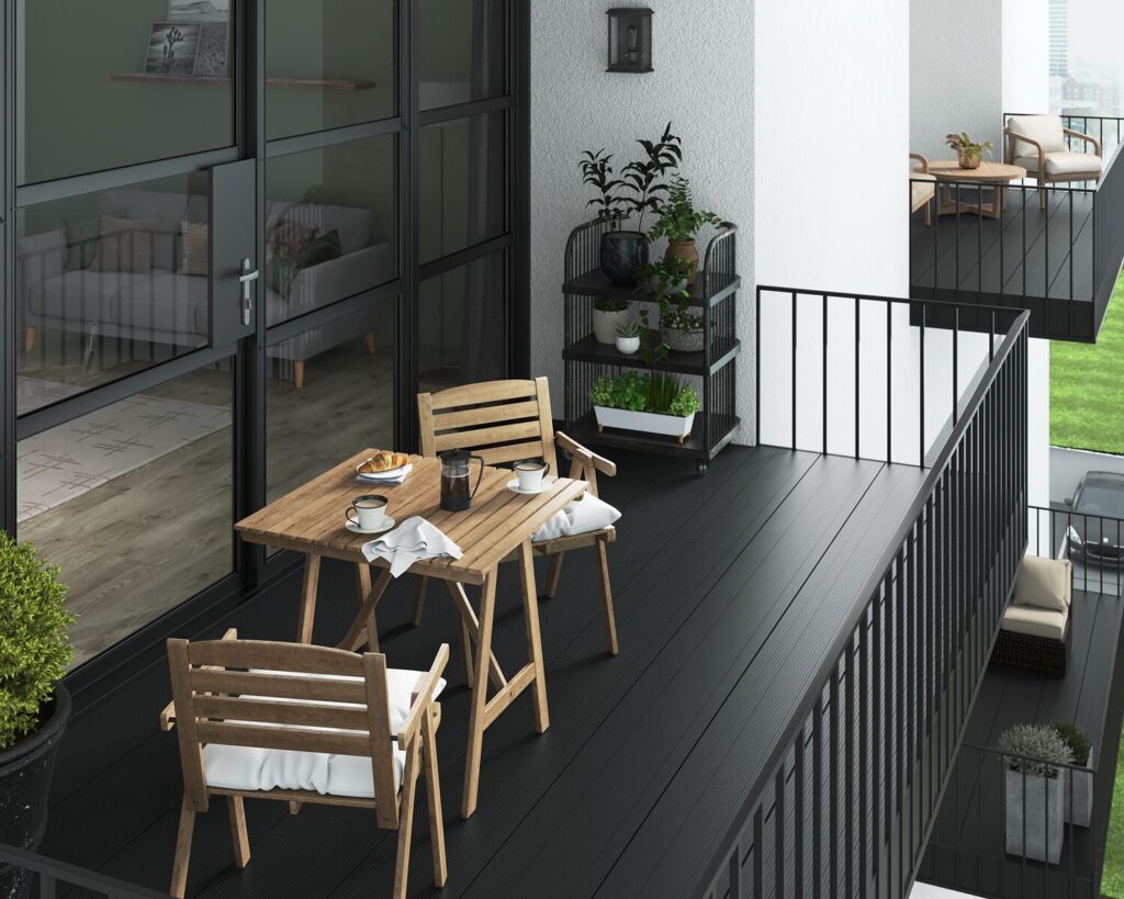A black aluminium balcony with wooden garden furniture